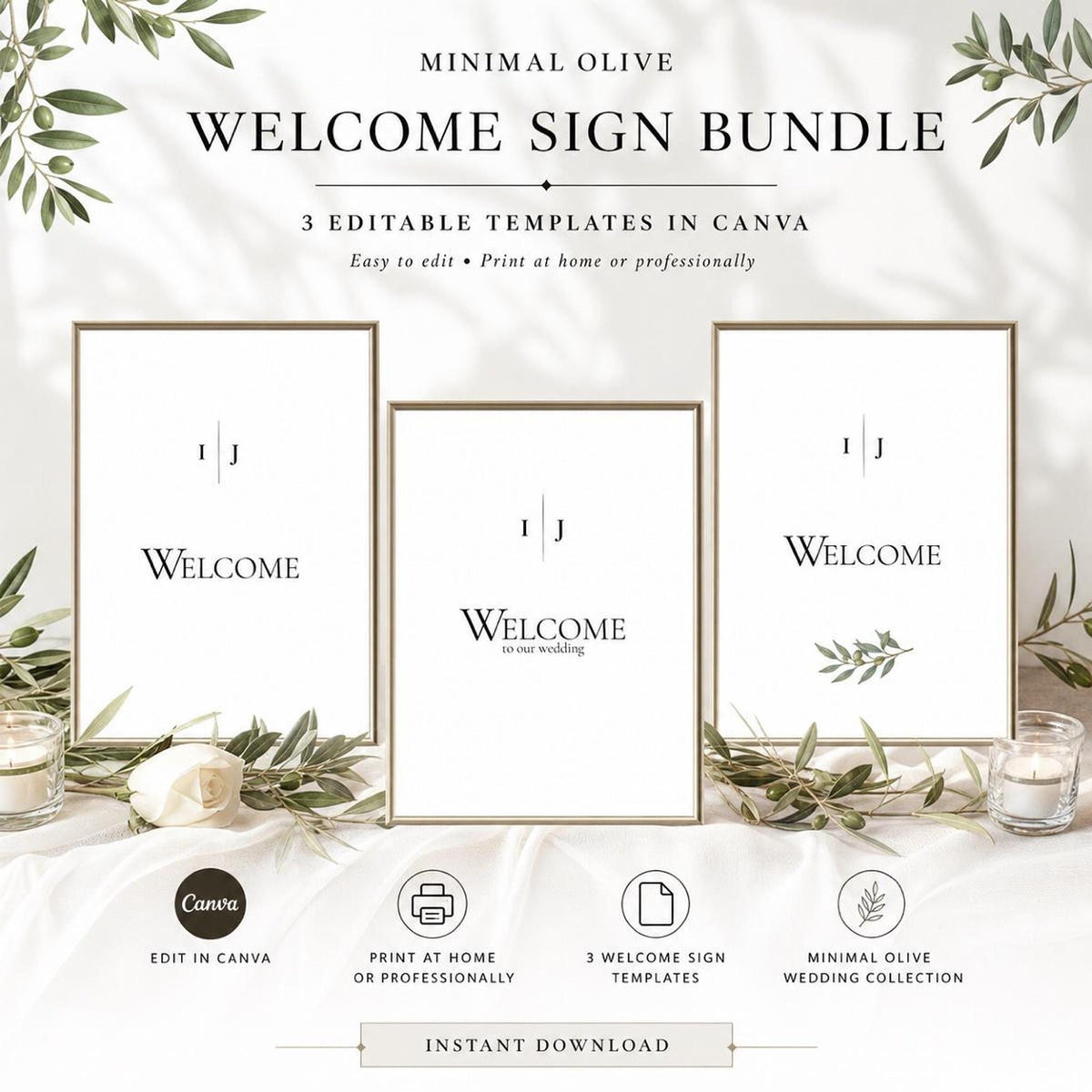 Three framed white "Welcome" signs with olive branch designs are displayed on a white fabric surface, surrounded by candles and white roses.
