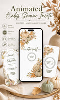 A smartphone displaying a baby shower invitation with watercolor pumpkins and fall foliage is surrounded by real pumpkins and dried leaves.