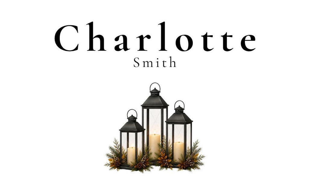 Three black lanterns with lit candles and evergreen accents are arranged in a group, with the name "Charlotte Smith" in black text above them.