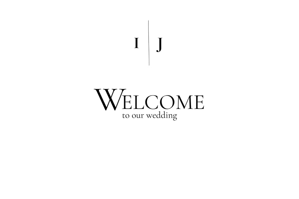 A white sign with black text reading "I J" separated by a vertical line, and below that, "WELCOME to our wedding."