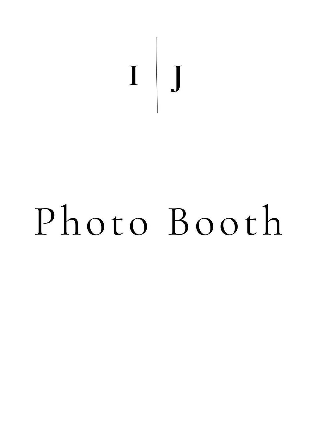 A white sign with black text reading "I J" separated by a vertical line, and below that, "Photo Booth."