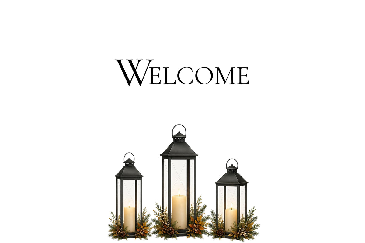 A white card with black text reading "Welcome" above three black lanterns with candles and pine sprigs.
