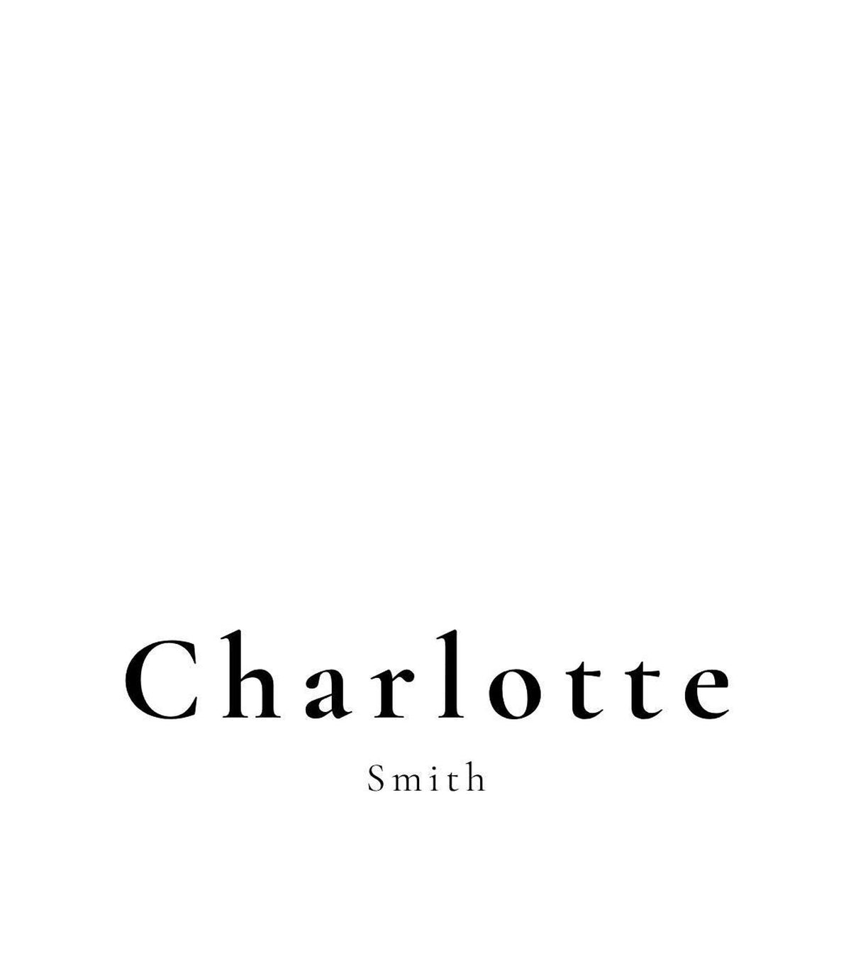 A white place card with the name "Charlotte Smith" in black text, centered on the card.