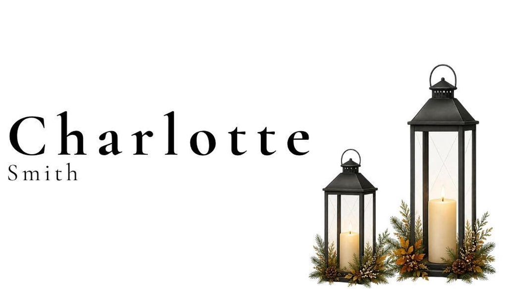 Two black lanterns with lit candles and evergreen accents are on the right, with the name "Charlotte Smith" in black text on the left.