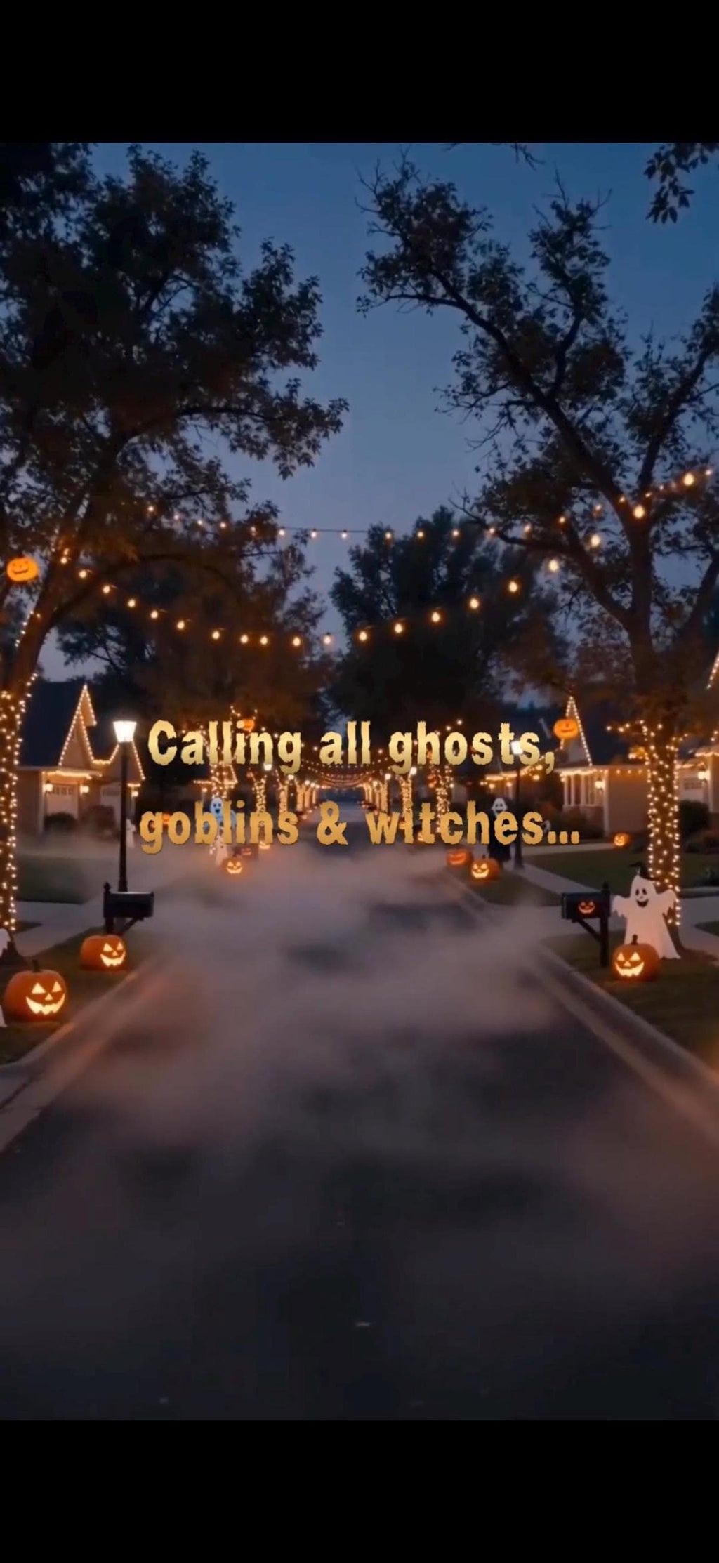 A street at dusk is decorated for Halloween with glowing pumpkins and string lights, with a misty fog in the middle of the road and text "Calling all ghosts, goblins & witches..." superimposed.