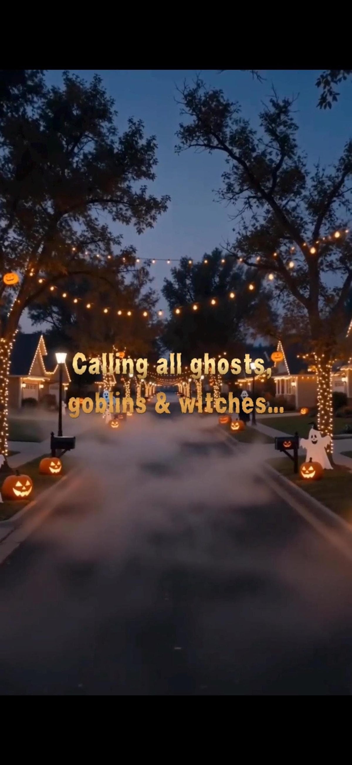 A street at dusk is decorated for Halloween with glowing pumpkins and string lights, with a misty fog in the middle of the road and text "Calling all ghosts, goblins & witches..." superimposed.