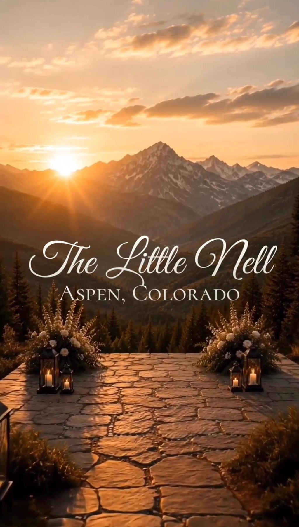 A stone terrace overlooking mountain ranges at sunset with floral arrangements, displaying the text The Little Nell Aspen Colorado.